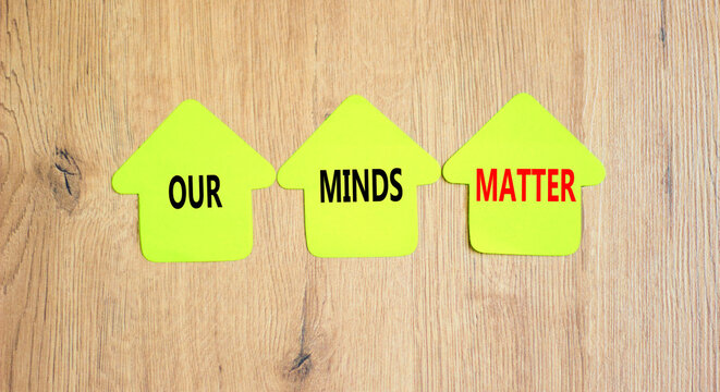 Our minds matter ourmindsmatter symbol. Concept words Our minds matter on beautiful yellow paper house. Beautiful wooden background. Our minds matter ourmindsmatter concept. Copy space.