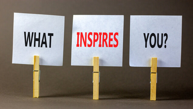 What inspires you symbol. Concept words What inspires you on beautiful white paper on clothespin. Beautiful grey background. Business motivational what inspires you concept. Copy space.