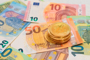 A Stack of Bitcoin Coins on the Euro Banknotes. Money Saving, Cryptocurrency, Blockchain and Anonymous Payments Concept