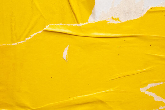 Old grunge ripped torn yellow paper poster surface texture background