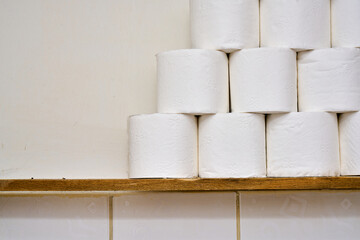 White toilet paper on a bathroom shelf.