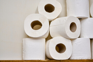White toilet paper on a bathroom shelf.