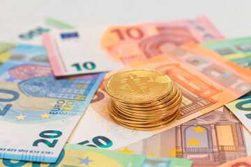A Stack of Bitcoin Coins on the Euro Banknotes. Money Saving, Cryptocurrency, Blockchain and Anonymous Payments Concept
