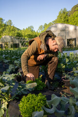 A young farmer hipster stands confidently in a lush green field, exuding a sense of connection to nature and a modern aesthetic. 