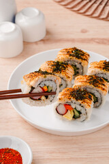 sushi is a Japanese dish of prepared vinegared rice, usually with some sugar and salt, accompanied by a variety of ingredients such as seafood, often raw and vegetables.