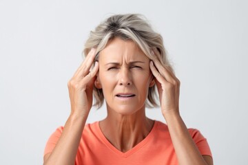 Portrait of a mature woman suffering from headache isolated on a white background