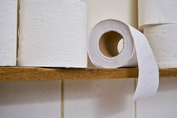 White toilet paper on a bathroom shelf.