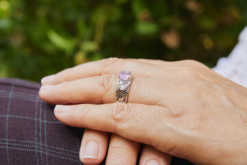 Side Zoom View Woman's Hand and Pink Wedding Ring