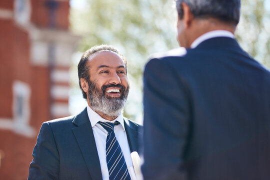 Smiling businessman talking with his colleague
