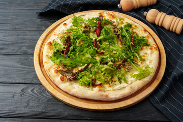 Fresh tasty pizza on black wooden background