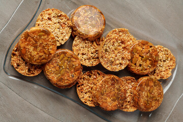 Crunchy homemade cookies on glass plate on gray background