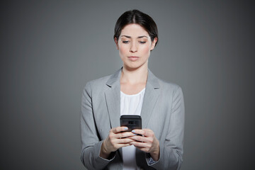 Portrait of young woman text messaging.