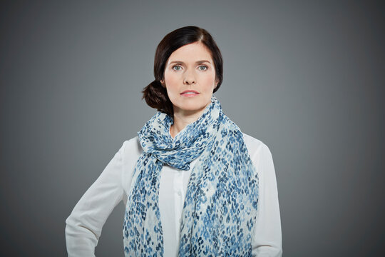 Portrait of mid adult woman wearing patterned scarf.
