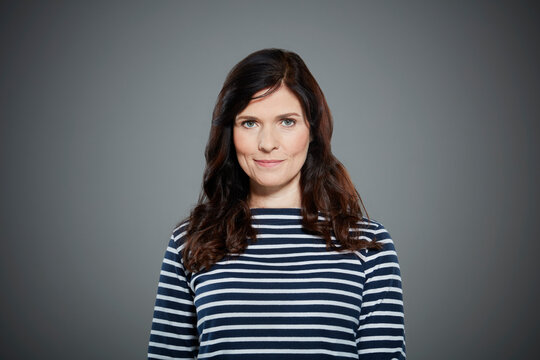 Portrait of mid adult woman wearing striped shirt.