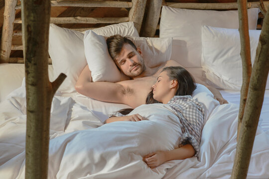 Young couple sleeping together.