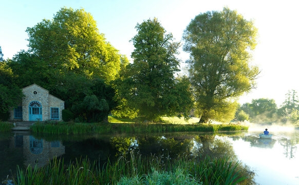 Riverside house and man in rowboat