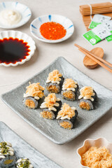 sushi is a Japanese dish of prepared vinegared rice, usually with some sugar and salt, accompanied by a variety of ingredients such as seafood, often raw and vegetables.
