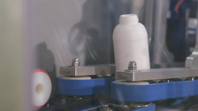 food production white plastic bottles on conveyor belt, fa01