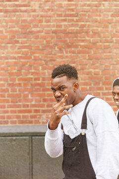 Young man making gang sign