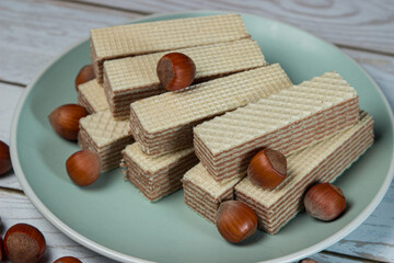 Wafers with nut filling on a plate with hazelnuts