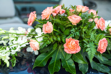 Bouquet of pink and white flowers on car