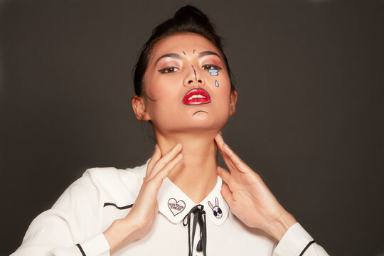 Young woman with face paint tears and lines