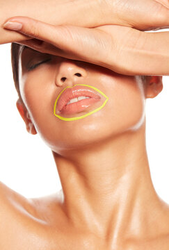 Young woman with yellow circle around her mouth shielding her eyes