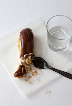 Chocolate eclair and glass of water