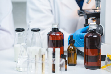 Food scientist testing new stuff samples of dairy products in the laboratory, female laboratory...