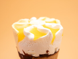 Lemon ice cream waffle cups. Ice cream on an orange background.