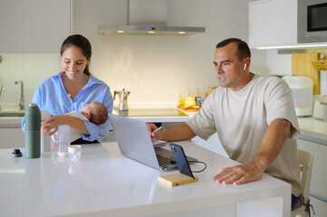 Happy family sitting in kitchen