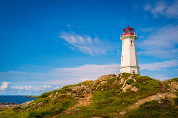 Fototapeta na wymiar Louisbourg Lighthouse, an active Canadian lighthouse, in Louisbourg on Cape Breton, Nova Scotia 