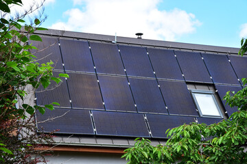 Solar energy power panel on a house roof - 633064314