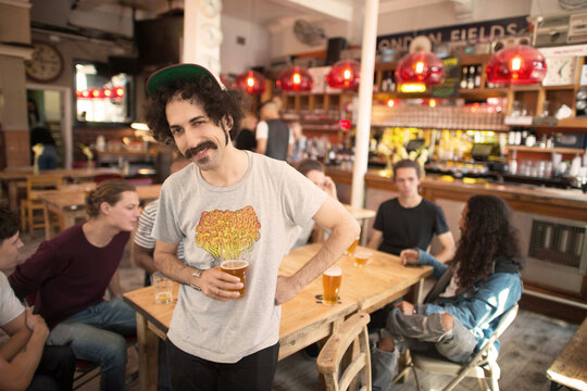 Young man spending time with friends at bar