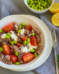 wholewheat pasta salad with tomatoes, beans and cheese