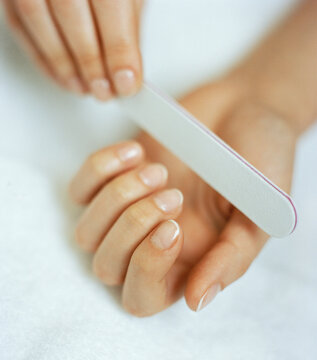 Woman filing nails
