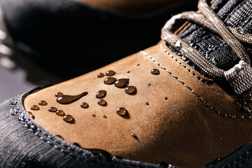 waterproof leather boots. closeup of rain drops on water resistant footwear. weatherproof clothing