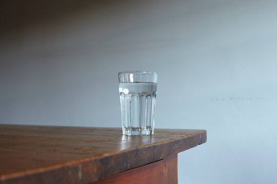 Glass of water on wooden table