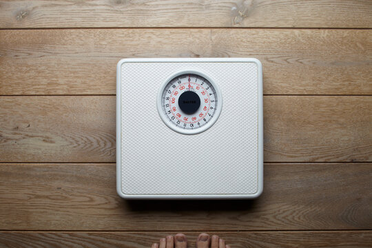 Weight scale on wooden floor
