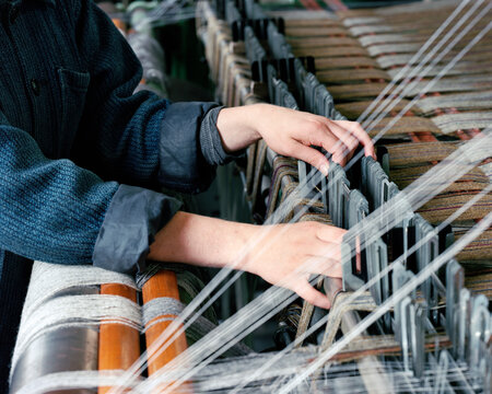 Hands of woman using loom