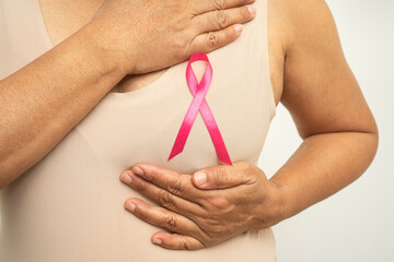 Asian woman patient checking and worry her breast, Breast Self Exam or BES, symbol of World Breast Cancer Day.