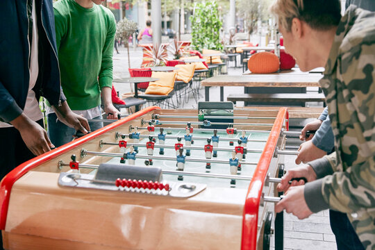 Teenage boys playing table football