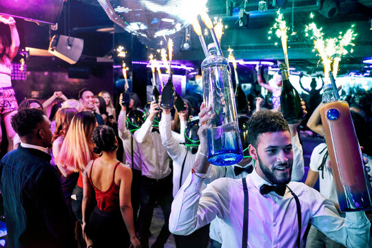 Bartenders with sparklers at nightclub