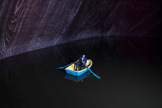 Young man in rowboat on lake