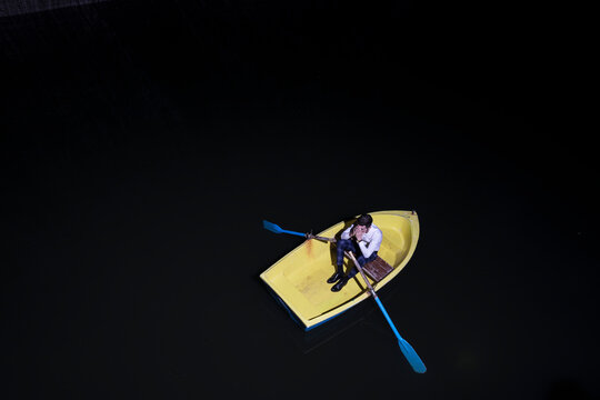 Young man in rowboat on lake