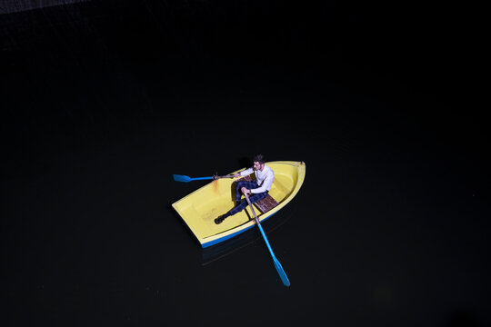 Young man in rowboat on lake