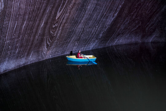 Young woman in rowboat on lake