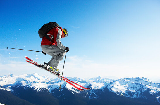 Man jumping while skiing on mountain