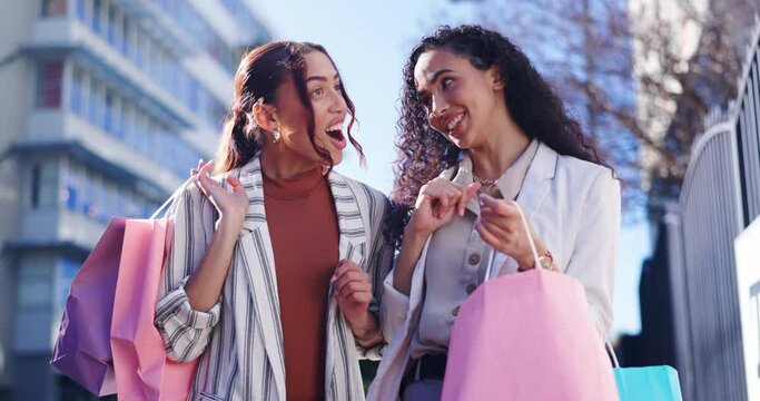 Happy woman, friends and walking with shopping bag in city together for discount, sale or outdoor purchase. Women or shopper smile in happiness for retail, deal or bonus promotion in an urban town