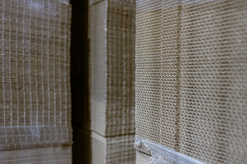 Folding cardboard boxes. Perforated sheets of corrugated cardboard a stack on pallets. Packaging of finished products in industrial production.